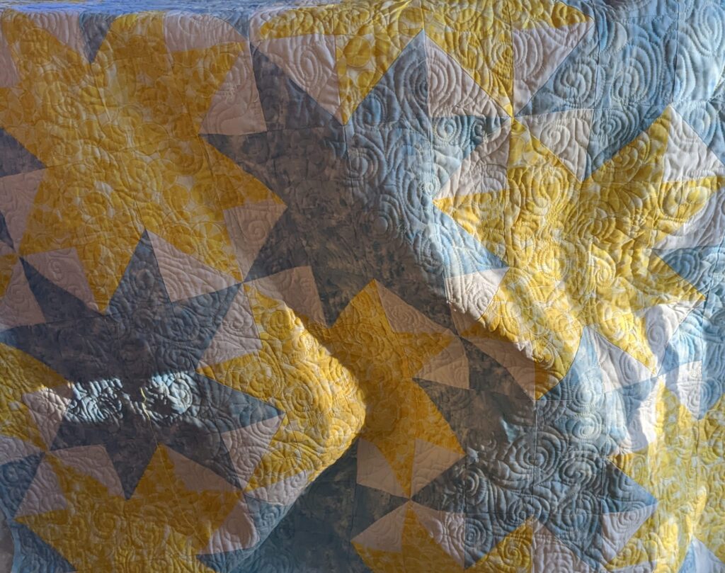 The completed quilt, quilted with swirls.