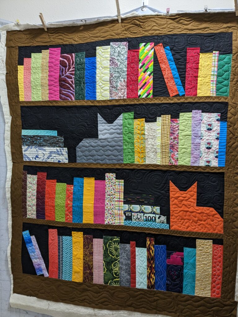 Entire bookcase quilt prior to being squared or binding.