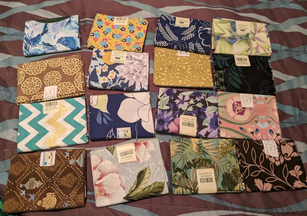 Sixteen fat quarters I purchased as part of my latest fabric haul.