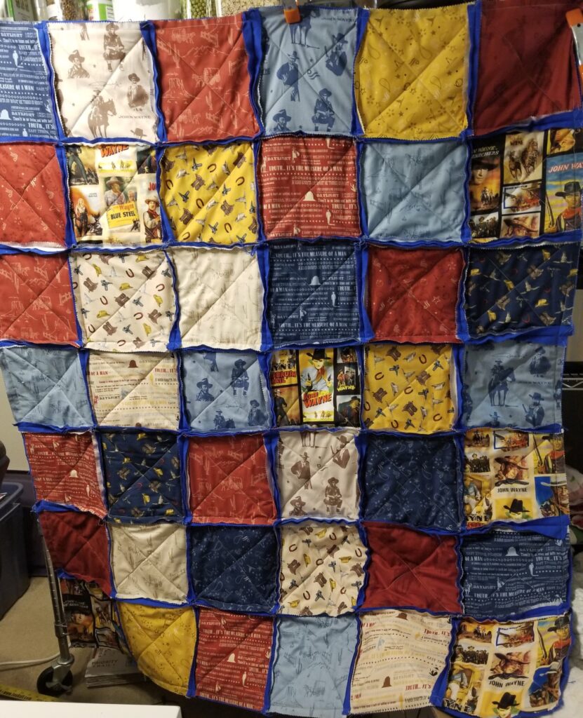Rag quilt made out of John Wayne fabric.