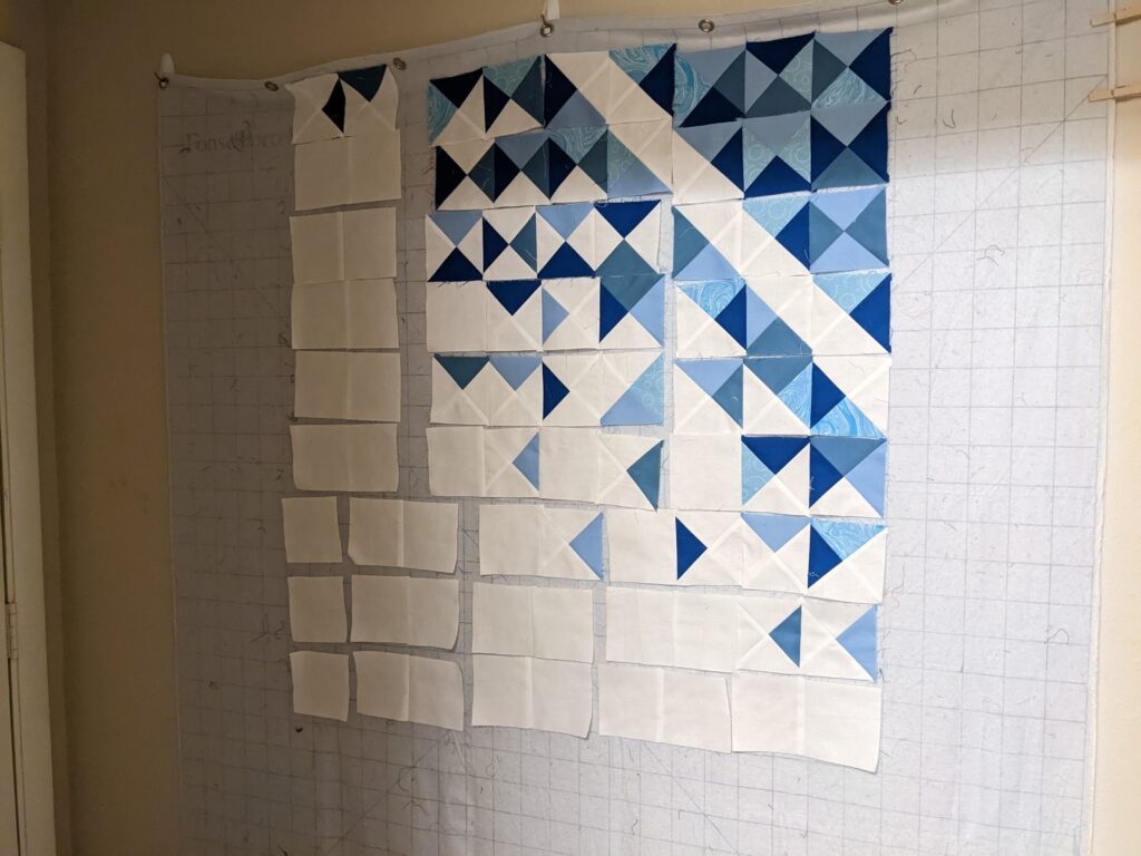 One quarter of the Exploding Heart quilt on my design wall.