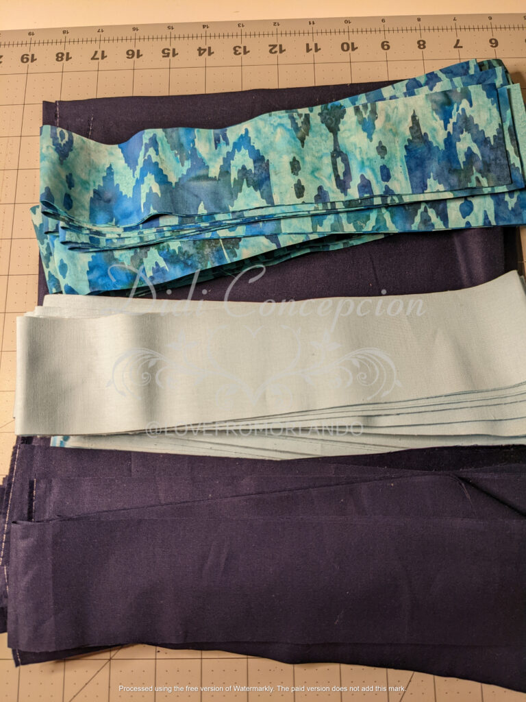 2.5" strips of fabric in three coordinating blues ready for sub-cutting.