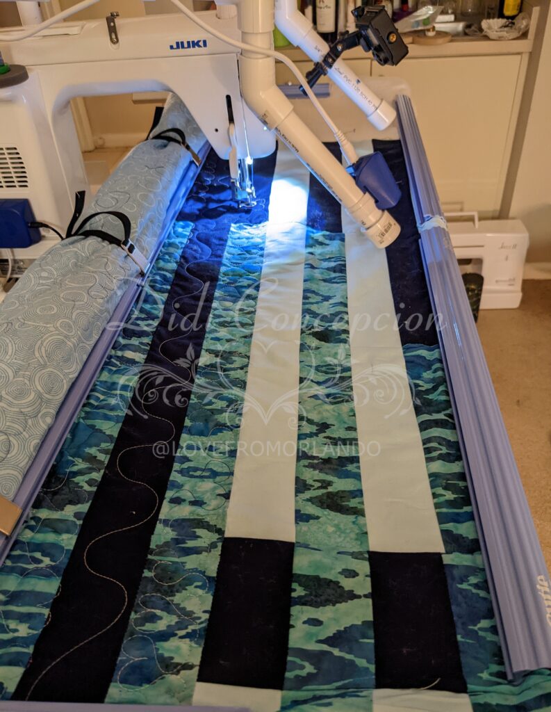 My Juki TL2000Qi sewing machine on the Cutie frame with the blue Through Love Quilt ready to quilt.