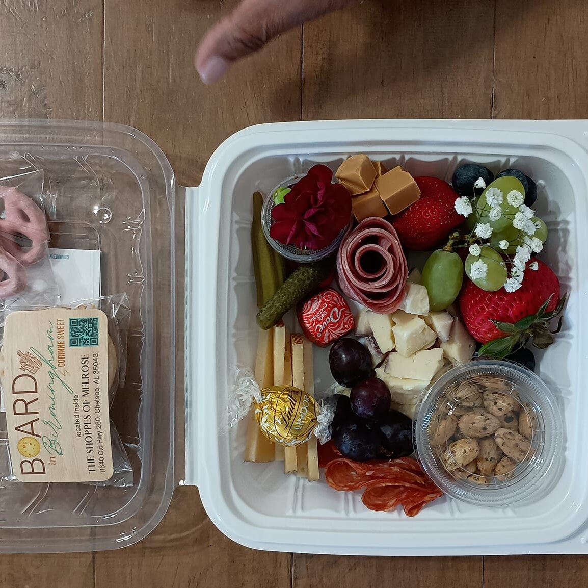 A charcuterie board in a to go container.