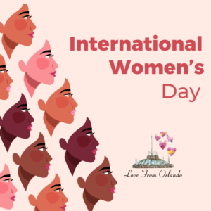 Text reading: International Women's Day with an image of many different faces of women and the Love From Orlando logo.